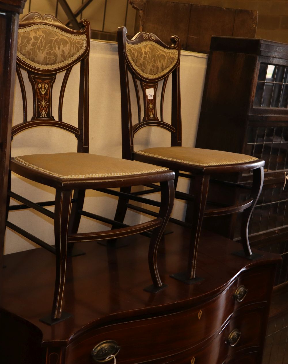 A pair of late Victorian marquetry inlaid mahogany salon chairs